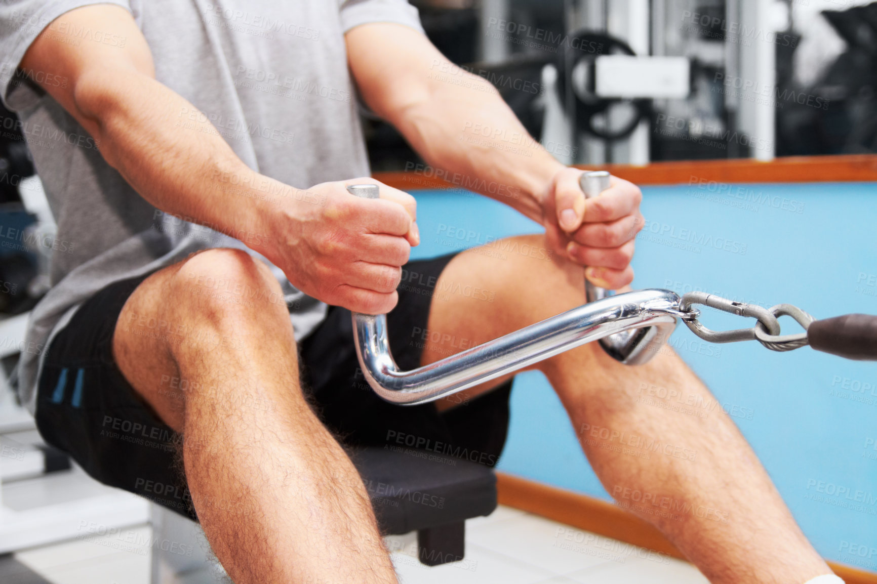 Buy stock photo Hands, gym and rowing machine with man, fitness and workout for health, wellness and strong body. Bodybuilder guy, exercise and training with weightlifting, focus and healthy with muscle development
