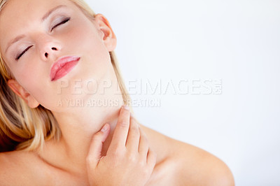 Buy stock photo Beautiful young woman touching her skin against a white background