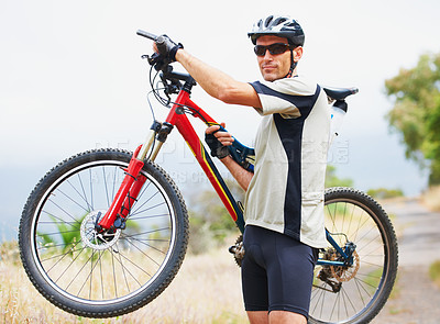 Buy stock photo Portrait, bicycle and fitness with a man in the mountains for cardio training, recreation or summer hobby. Sports, cycling and freedom with a confident young athlete outdoor for eco friendly exercise