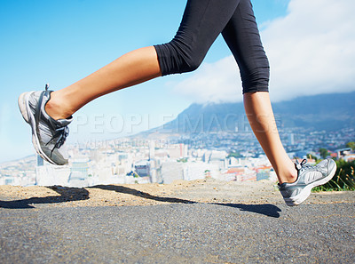 Buy stock photo Cropped shot of a sporty woman going for a run outdoors