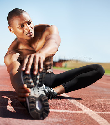 Buy stock photo Man, training and stretching leg on ground, outdoors and fitness for health, sports and performance. Black male person, athlete and warmup on track, workout and commitment or ready, floor and cardio