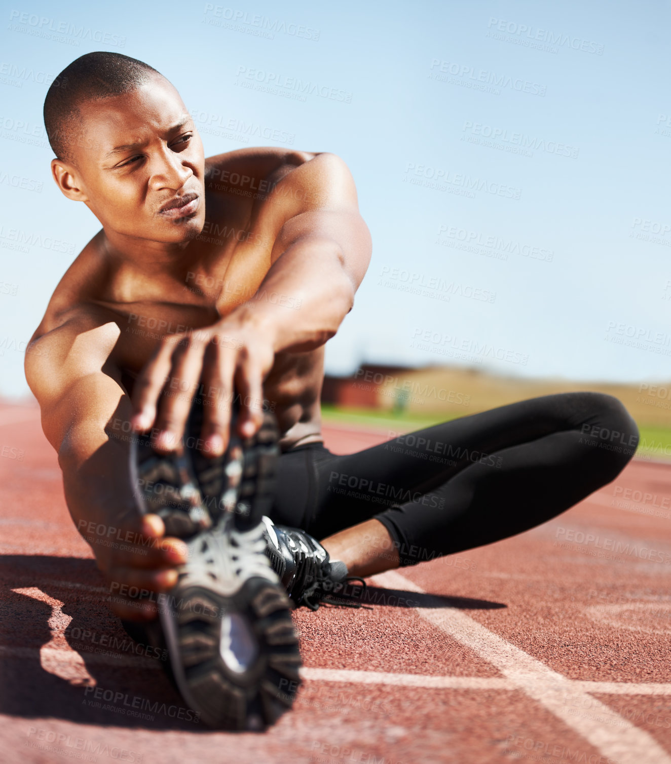 Buy stock photo Man, training and stretching leg on ground, outdoors and fitness for health, sports and performance. Black male person, athlete and warmup on track, workout and commitment or ready, floor and cardio