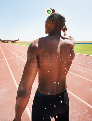 Buy stock photo Man, bottle and pouring water or fitness, outdoors and liquid for refreshment, hydration and cool down. Black male person, back and athlete or splash, hot and exhausted from workout, training or race