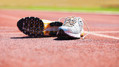 Buy stock photo A pair of running shoes lying on a running track