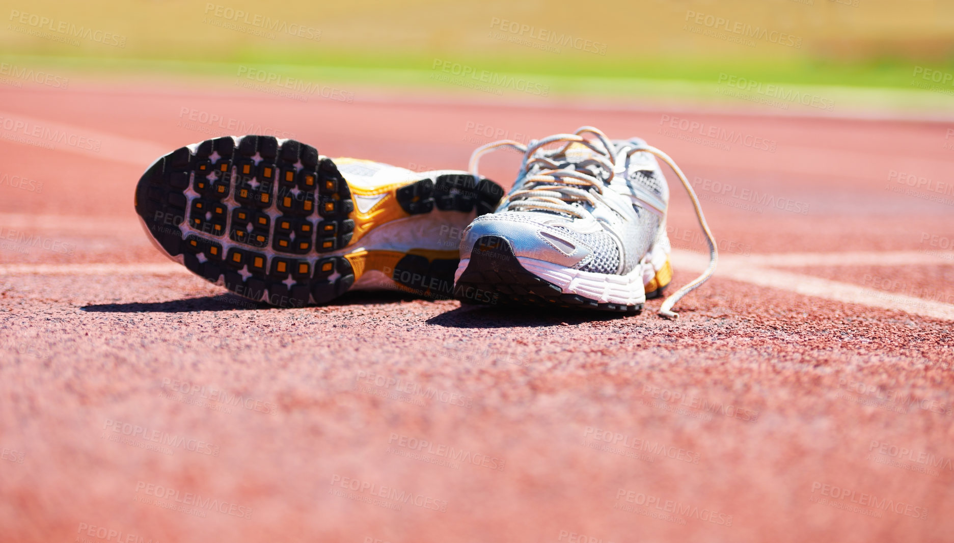 Buy stock photo A pair of running shoes lying on a running track