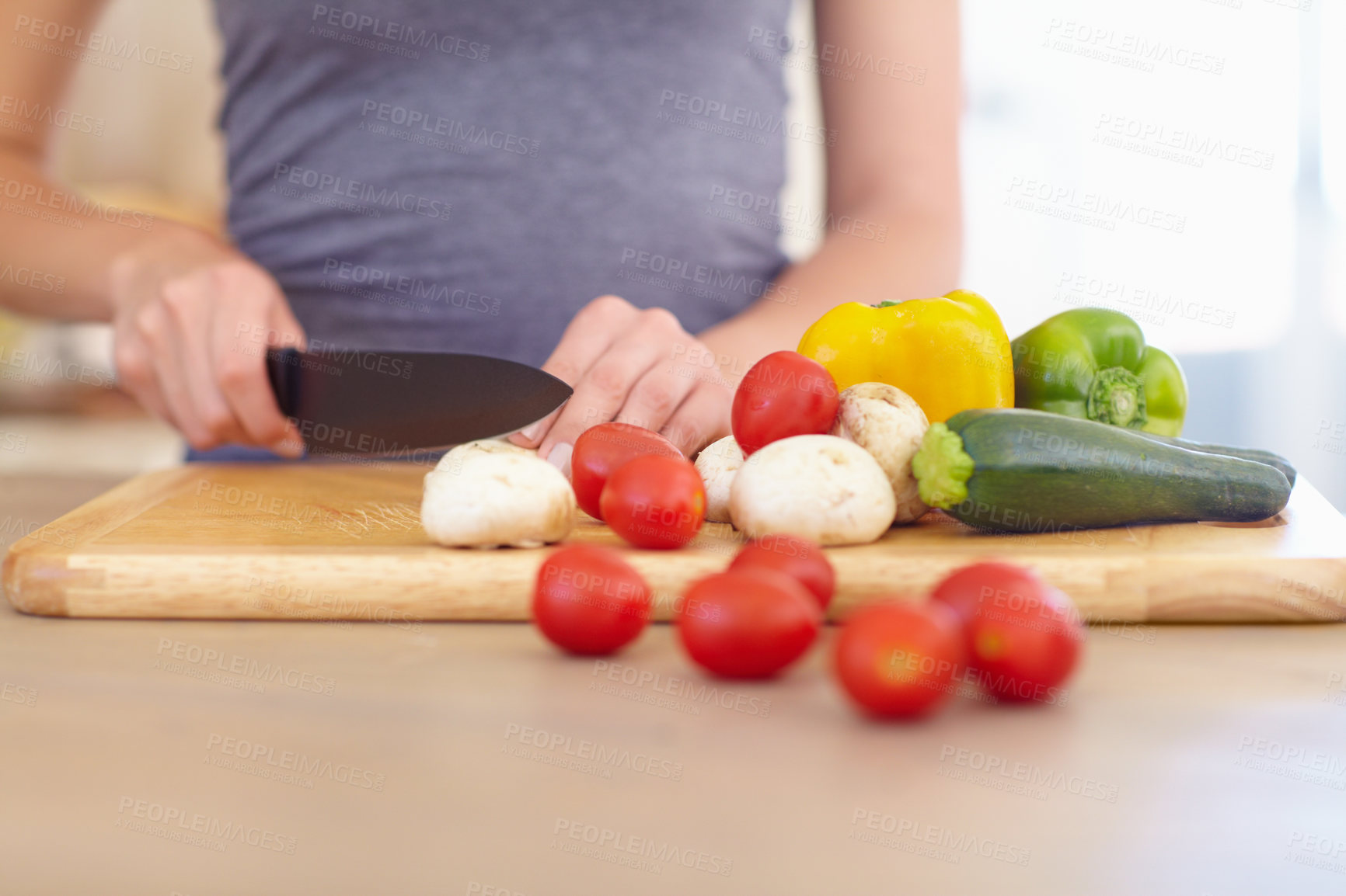 Buy stock photo Cropped image of a woman chopping up vegetables in the kitchen