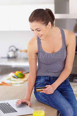 Buy stock photo Laptop, credit card and online shopping with a woman in the kitchen of her home for ecommerce payment. Computer, finance and orange juice with a young customer in her apartment for internet banking