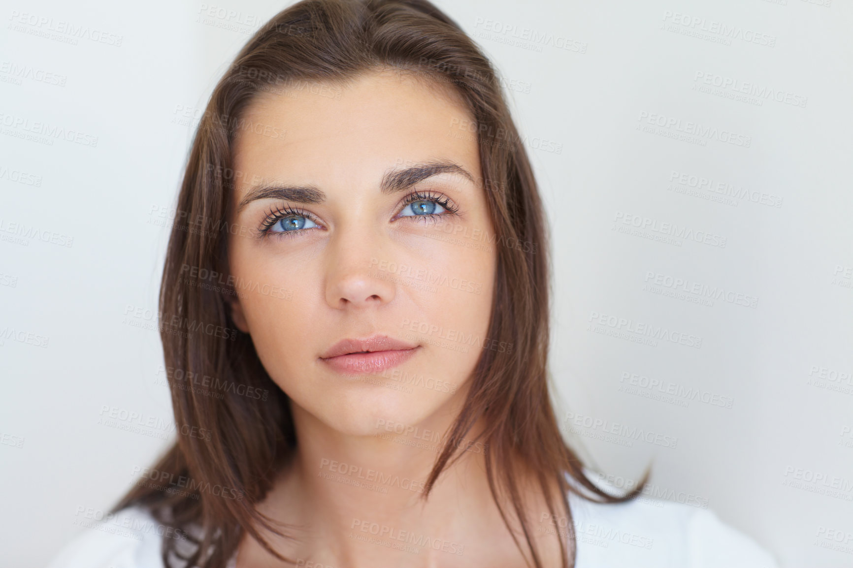 Buy stock photo A gorgeous young woman looking away thoughtfully