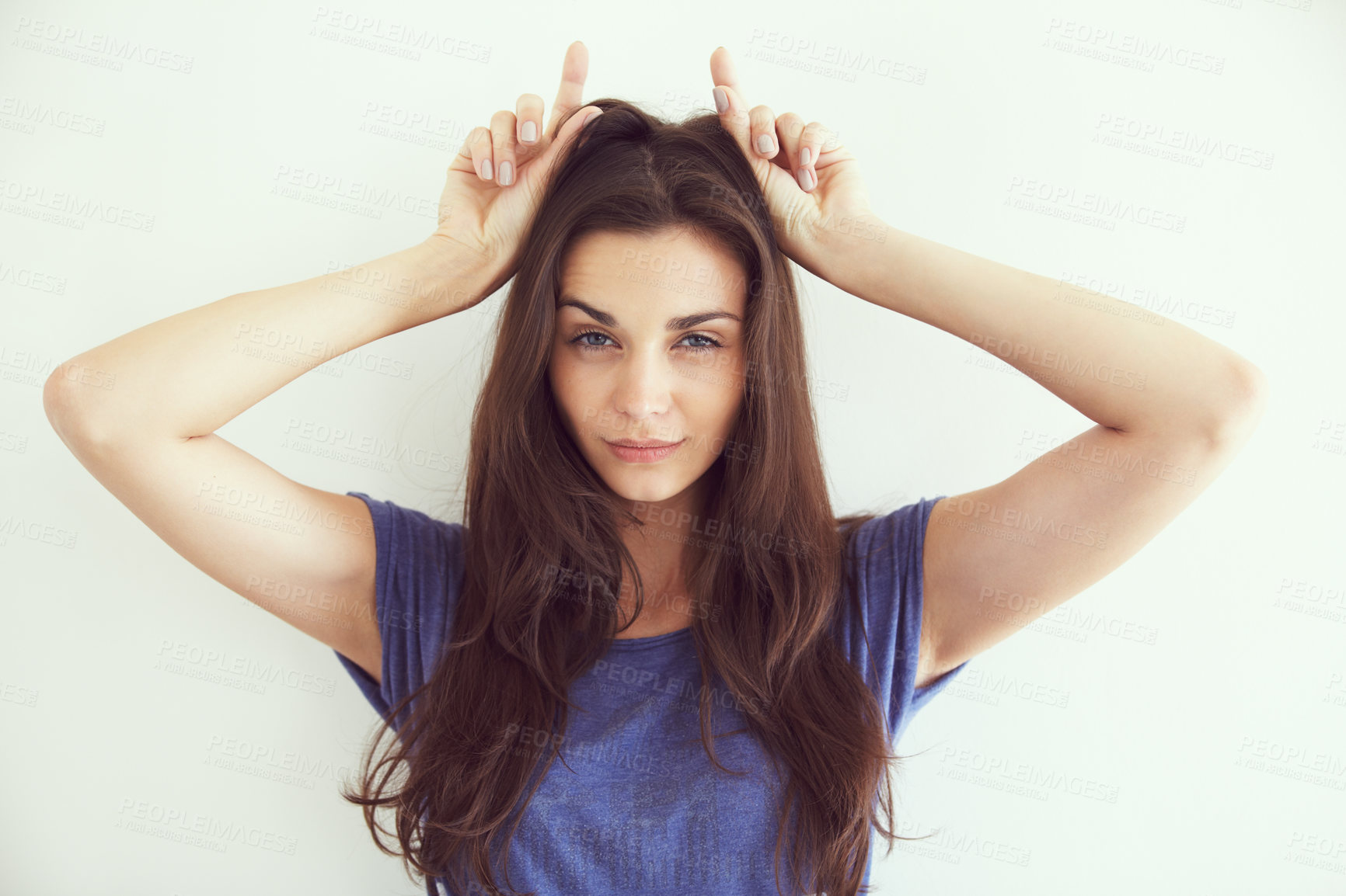 Buy stock photo Portrait of an attractive young woman making devil horns