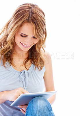 Buy stock photo Young woman using her digital tablet with a smile