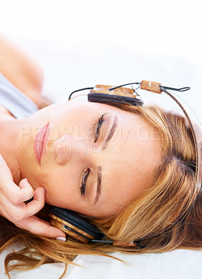 Buy stock photo Woman, face and relax with headphones listening to music isolated on a white studio background. Closeup of calm female person lying with headset in podcast, radio or audio streaming for sound track