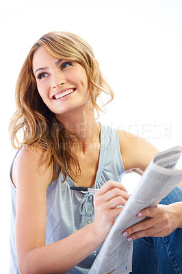 Buy stock photo Woman, reading and crossword with newspaper, puzzle and games in studio, smile and pen by white background. Girl, paper and happy with writing, problem solving and language challenge with strategy