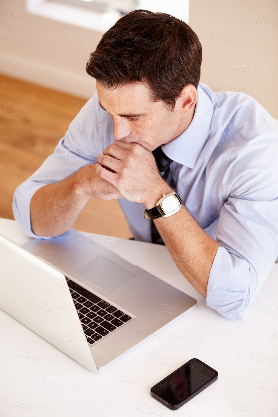 Buy stock photo Young businessman sitting with his arms crossed in front of his laptop