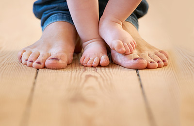 Buy stock photo Closeup, feet and mother with baby in their home for walking, learning and love, bonding and routine. Toes, legs and parent with toddler on a floor for support, playing and fun, help and motor skills