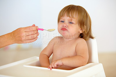 Buy stock photo Baby, chair and eating food or unhappy mood for health meal, childhood development or upset. Hand, spoon and feed seat or tired fail kid for dinner or disappointed face or distress, care or problem
