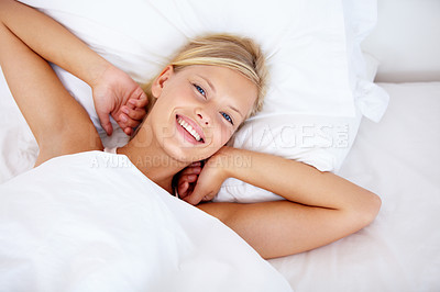 Buy stock photo Portrait, wake up and a woman stretching in bed from above after sleeping in the bedroom of her home. Face, smile and happy with an attractive young female lying on a pillow in the morning to relax