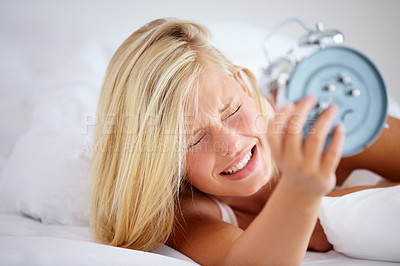 Buy stock photo Alarm, clock and woman in bed, late and snooze to rest with anxiety, frustrated and lady in a home. Tired, sleep or lazy with girl, appointment or person in bedroom on morning weekend, time or stress