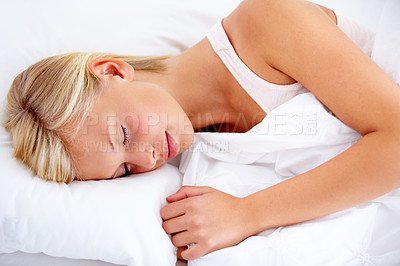 Buy stock photo Bedroom, woman and sleeping with peace, fatigue or home with comfort, tired or resting while dreaming. Apartment, girl or exhausted person, taking a nap with a comfortable pillow, relax or blanket