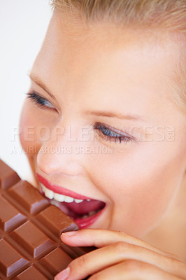 Buy stock photo Studio face, woman and eating chocolate slab bar, delicious snack or unhealthy junk food, dessert or sugar candy. Wellness craving, beauty skin and person bite sweets isolated on white background