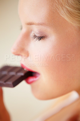 Buy stock photo Relax woman face, eating and bite chocolate bar, tasty cocoa snack or unhealthy junk food for wellness, stress relief or craving. Head profile, antioxidant product benefits and girl enjoy cacao slab