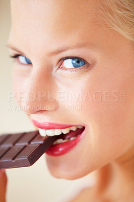 Buy stock photo Portrait, eating or happy woman bite chocolate bar, snack or junk food for wellness, stress relief or craving. Face headshot, delight or girl taste cacao slab, antioxidant benefits or diet cheat meal
