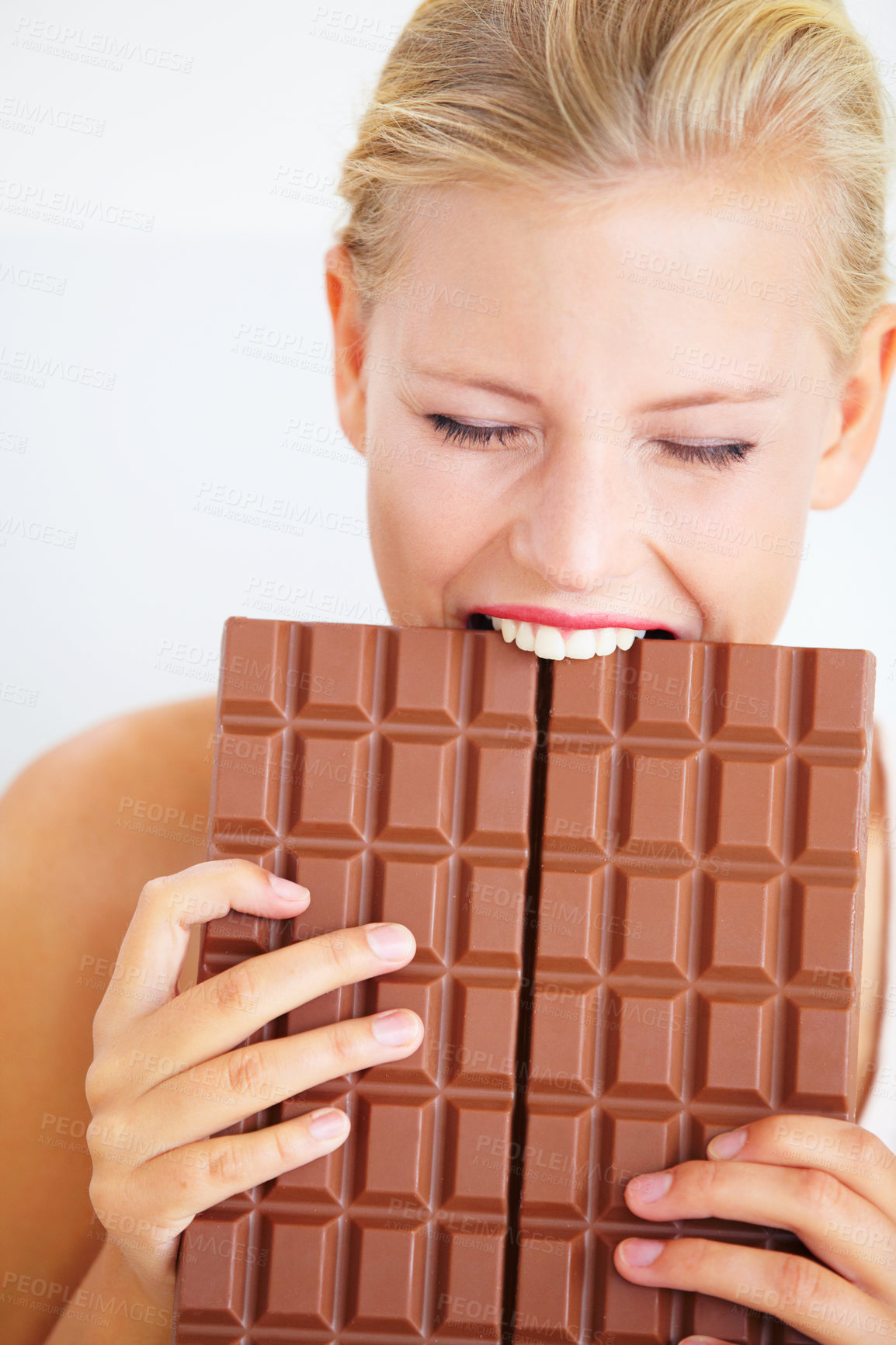 Buy stock photo Eating woman, hungry and bite chocolate bar, delicious snack or candy for studio food, dessert or sugar craving. Diet cheat meal calories, diabetes or girl hunger for cacao sweets on white background