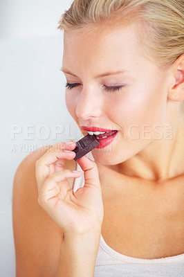 Buy stock photo Relax woman face, eating and enjoy chocolate bar, delicious snack or studio wellness candy, junk food or dessert product. Diet nutrition, sugar addiction temptation or female person bite cacao sweets