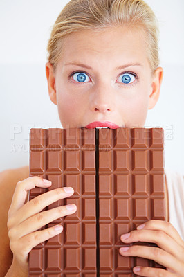 Buy stock photo Surprise portrait, woman and eating chocolate bar, delicious snack or candy for studio food, dessert or sugar product. Wow facial expression, cacao sweets or shocked face isolated on white background