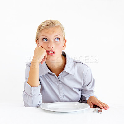 Buy stock photo Bored, hungry and woman with a plate in a studio with upset, frustrated and grumpy face. Angry, moody and young female person from Australia with dish and cutlery isolated by white background.