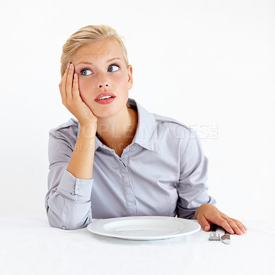 Buy stock photo Bored, upset and woman with a plate in a studio with starving, frustrated and grumpy face. Angry, hungry and young female person from Australia with dish and cutlery isolated by white background.