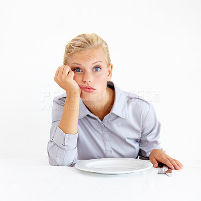Buy stock photo Hungry, portrait and woman with a plate in a studio with upset, frustrated and grumpy face. Bored, moody and young female person from Australia with dish and cutlery isolated by white background.