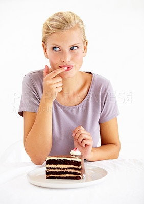 Buy stock photo Sneaky, cake and young woman in a studio cheating on healthy, wellness or weight loss diet. Yummy, sweet and female person from Australia eating a chocolate dessert isolated by white background.