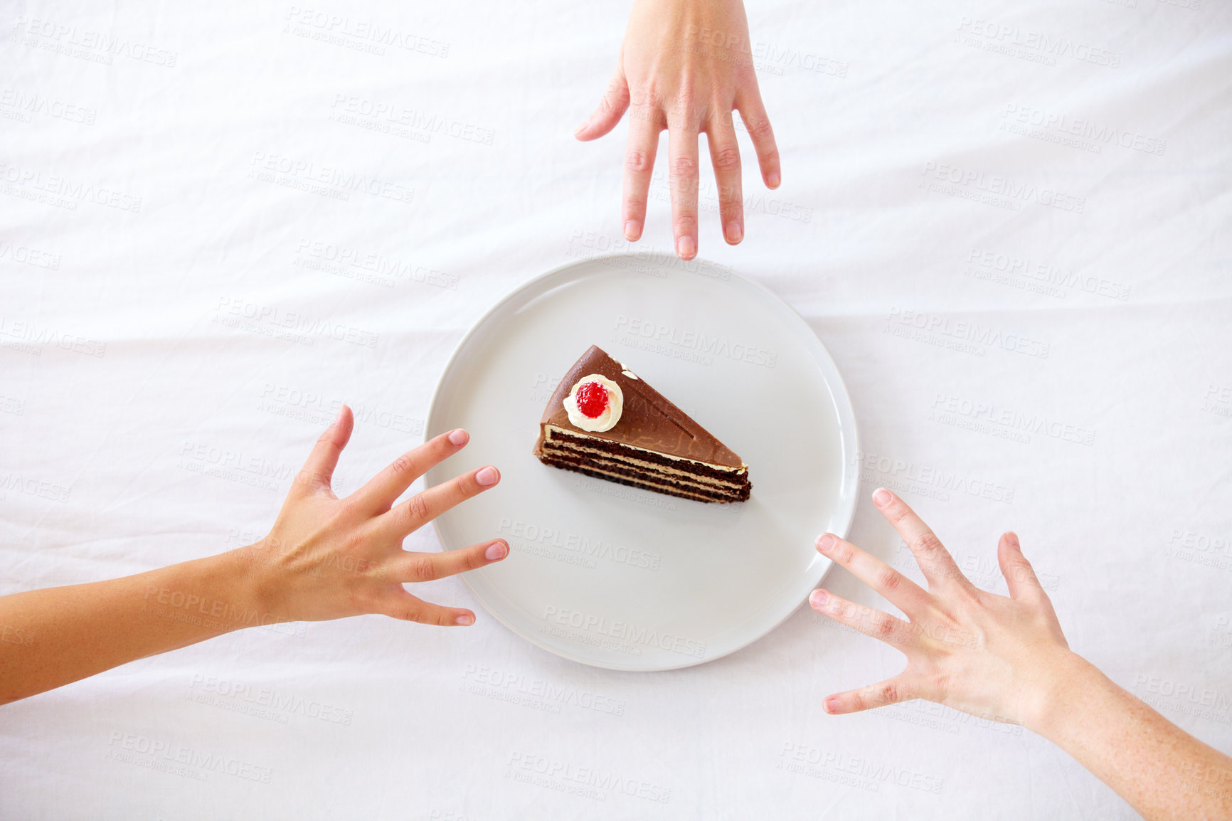 Buy stock photo Three hands reaching for the last piece of cake