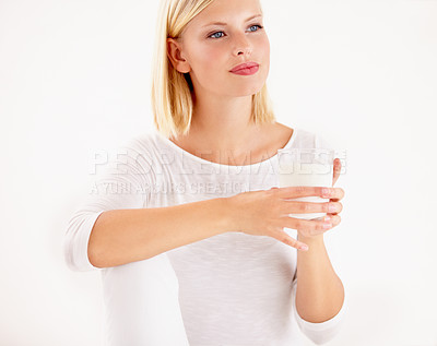 Buy stock photo Idea, milk and detox with a woman drinking from a glass in studio isolated on a white background. Idea, nutrition and calcium with a healthy young female enjoying a drink for vitamins or minerals