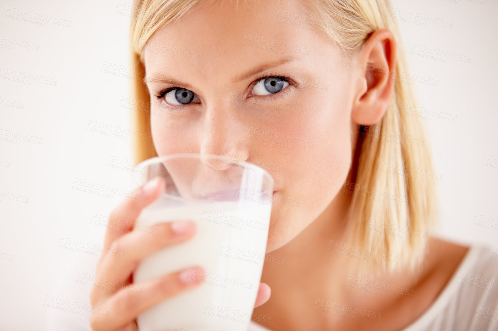 Buy stock photo Shot of a young woman enjoying a drink