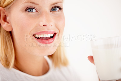 Buy stock photo Portrait, milk and happy with a woman drinking from a glass in studio isolated on a white background. Smile, nutrition or calcium with a healthy young female enjoying a drink for vitamins or minerals