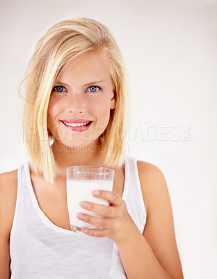 Buy stock photo Portrait, milk and health with a woman drinking from a glass in studio isolated on a white background. Healthy, nutrition and calcium with a young female enjoying a drink for vitamins or minerals