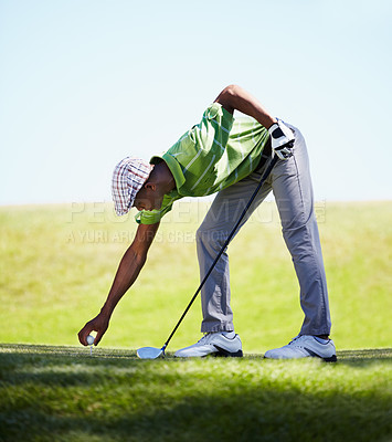Buy stock photo Sports, golfer and black man with golf ball on lawn for game, match and competition on golfing course. Recreation, hobby and male athlete with club driver on grass for training, fitness and practice