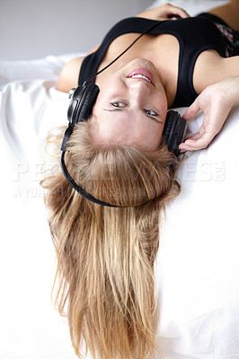 Buy stock photo Woman, headphones and music with smile on bed, thinking and listening for streaming subscription in home. Student girl, audio tech and relax with sound, radio or podcast with ideas, bedroom and house