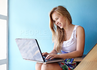 Buy stock photo Cropped shot of a young teen using a laptop in her bedroom