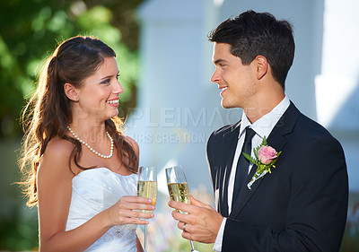 Buy stock photo Happy couple, wedding and champagne in celebration for marriage, love or commitment at outdoor ceremony. Married man and woman smile with glass of alcohol for toast, date or cheers on honeymoon