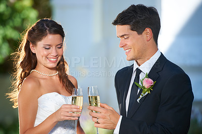 Buy stock photo Happy couple, wedding and champagne glasses in celebration for marriage, love or commitment at outdoor ceremony. Married man and woman smile with alcohol for toast, date or cheers on honeymoon