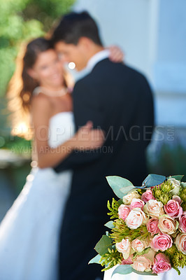 Buy stock photo Flower bouquet, happy couple and blurred embrace at wedding with love, smile and commitment at reception. Roses, woman and man hugging at marriage celebration event, partnership and future together.