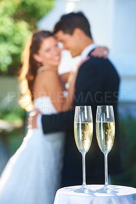 Buy stock photo Drinks, champagne and happy couple in embrace at wedding with love, smile and commitment at reception. Wine glass, woman and man hugging at marriage celebration event, partnership and future together