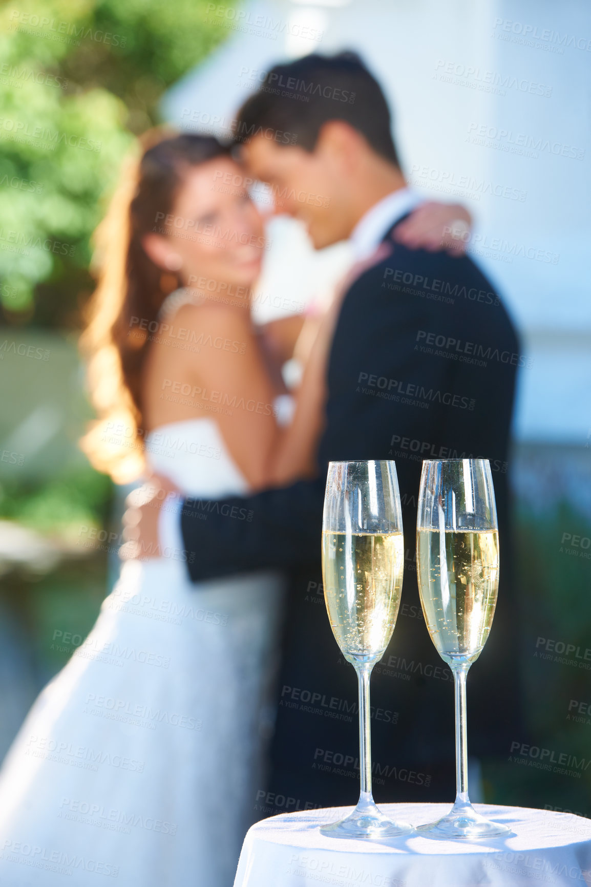 Buy stock photo Drinks, champagne and happy couple in embrace at wedding with love, smile and commitment at reception. Wine glass, woman and man hugging at marriage celebration event, partnership and future together