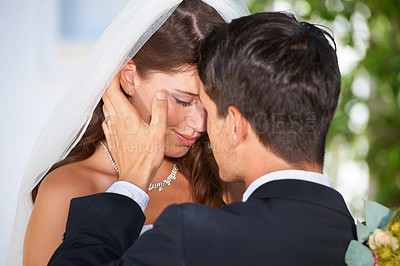 Buy stock photo Married couple, kiss and love at wedding for affection, marriage or romance together at outdoor ceremony. Man and woman in care, embrace or compassion for commitment, trust or loyalty in nature