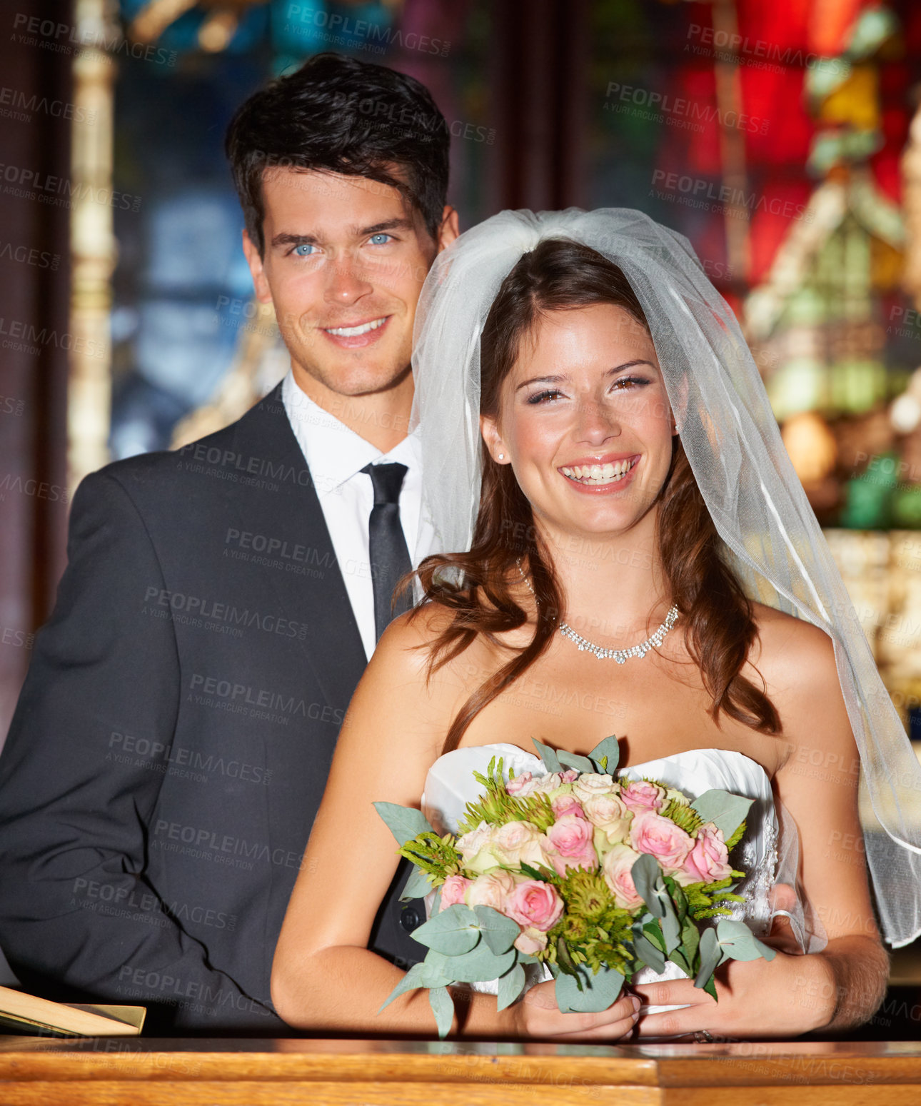 Buy stock photo Happy couple, wedding and flowers at church for love, marriage or commitment together at ceremony. Married man and woman smile with bouquet of roses and bridal dress for relationship or celebration