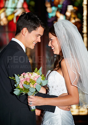 Buy stock photo Happy couple, wedding and love at church for commitment, marriage or affection together at ceremony. Married man and woman smile in joy with bouquet of roses or flowers for romantic relationship
