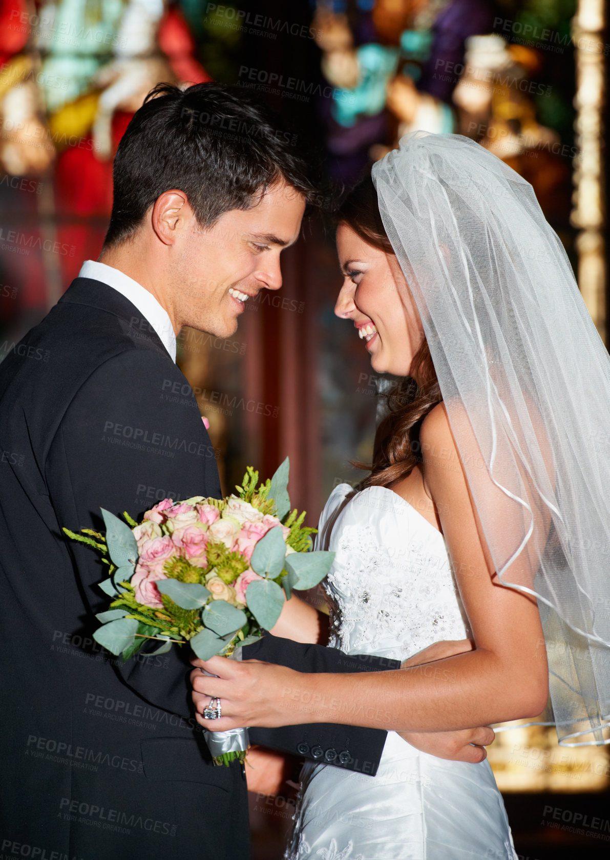 Buy stock photo Happy couple, wedding and love at church for commitment, marriage or affection together at ceremony. Married man and woman smile in joy with bouquet of roses or flowers for romantic relationship