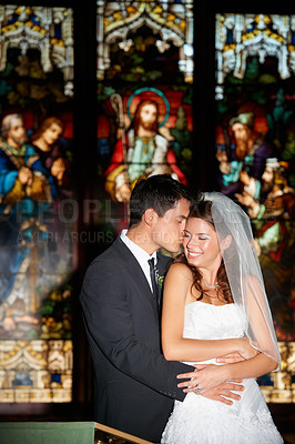 Buy stock photo Happy couple, hug and kiss at wedding in church for marriage love or vow in commitment together. Married man or groom hugging woman or bride smile for embrace, loyalty or support in trust at ceremony